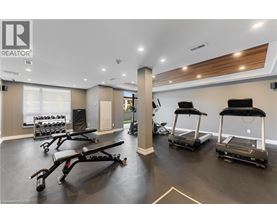 A gym with treadmills and weights is labeled REALTOR.