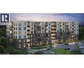 A modern apartment building with a parking lot in front.