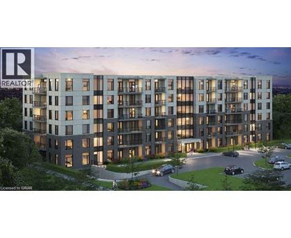 A modern apartment building with a parking lot in front.