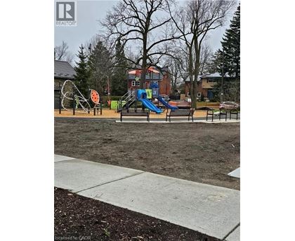 A playground with a slide and a seesaw.