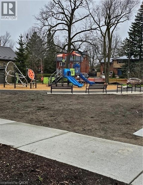 A playground with a slide and a seesaw.