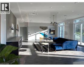 A modern living room with a blue couch and a wooden floor.