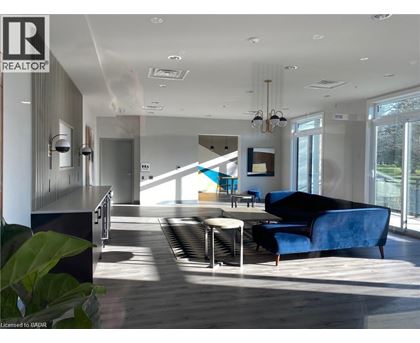 A modern living room with a blue couch and a wooden floor.