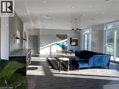 A modern living room with a blue couch and a wooden floor.