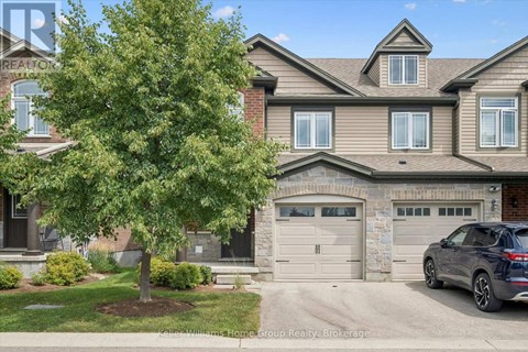 A house with a tree in front of it and a car parked in the driveway.