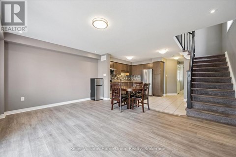 A spacious room with a dining table and chairs is shown.