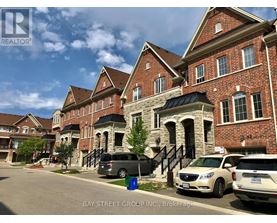 A row of houses with cars parked in front.