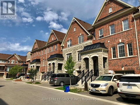 A row of houses with cars parked in front.