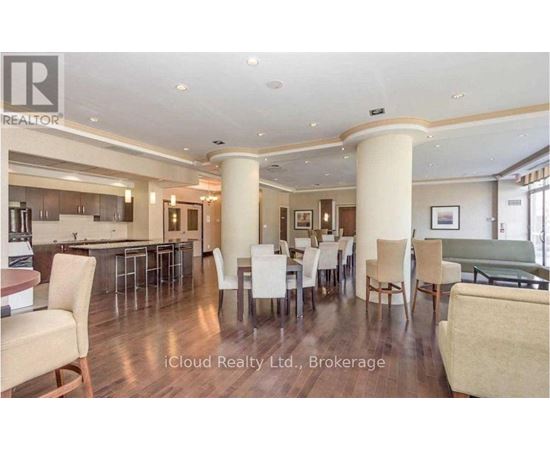 A spacious dining area with a bar and chairs.
