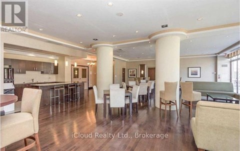 A spacious dining area with a bar and chairs.