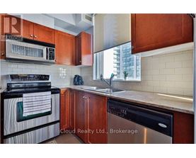 A kitchen with wooden cabinets and a black stove top oven.