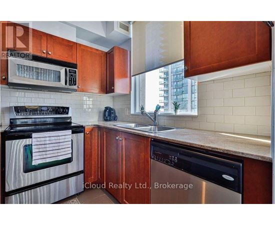 A kitchen with wooden cabinets and a black stove top oven.