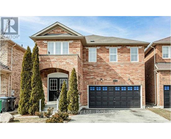 A brick house with a black garage door and a large front door.