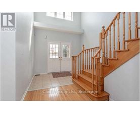 A wooden staircase with a carpeted landing.