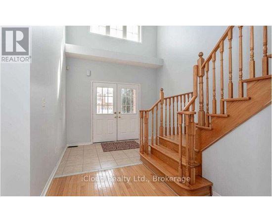 A wooden staircase with a carpeted landing.