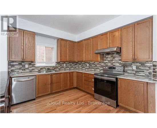 A kitchen with wooden cabinets and a stone backsplash.