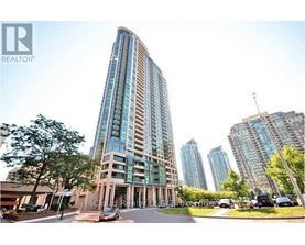 A tall building with a curved facade is the main focus of the image.