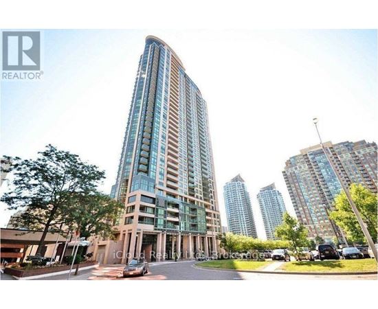 A tall building with a curved facade is the main focus of the image.