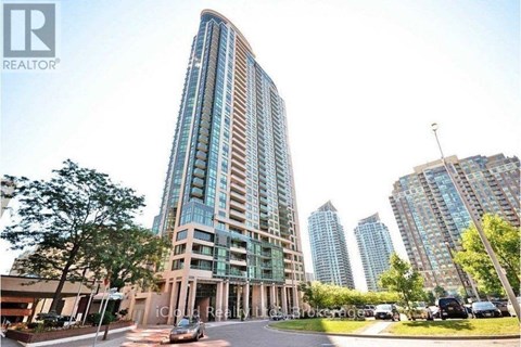 A tall building with a curved facade is the main focus of the image.
