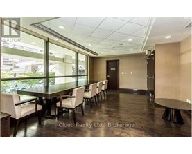 A conference room with a long table and chairs.