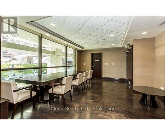 A conference room with a long table and chairs.