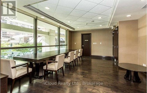 A conference room with a long table and chairs.