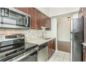A kitchen with a stove top oven, microwave, and refrigerator.