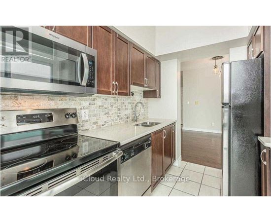 A kitchen with a stove top oven, microwave, and refrigerator.