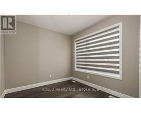 A room with a window covered by horizontal blinds.