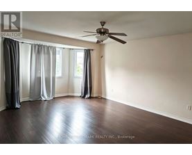 A room with a ceiling fan and sliding doors.