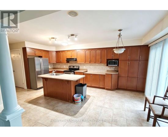 A kitchen with wooden cabinets and a refrigerator.