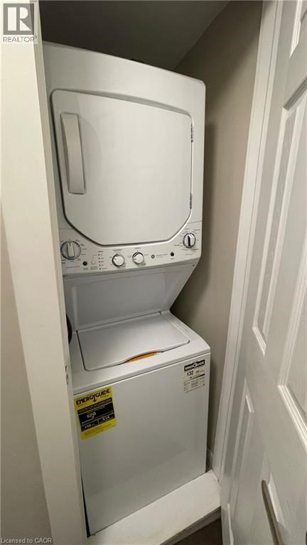 A white dishwasher with the door open is in a small space.