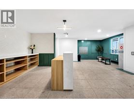 A room with a white ceiling and a wooden floor with a white column in the middle.