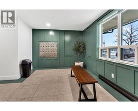 A room with a green wall and a wooden bench.