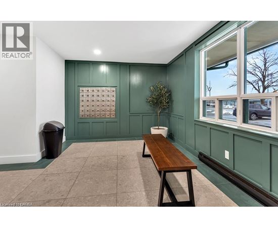 A room with a green wall and a wooden bench.