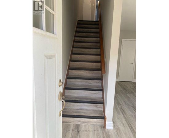 A staircase with wooden steps and a white door.