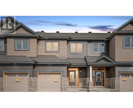 A row of houses with the sign RE/MAX West Realty Inc. Brokerage in front.
