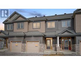 A modern two-story house with a garage on the left side.