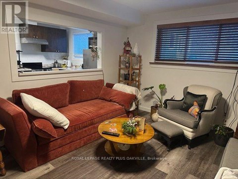A living room with a red couch and a grey armchair.