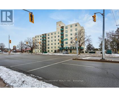A street view of a building with a sign that reads "REALTOR" and "MAX ESCARPMENT REALTY INC., Brokerage".