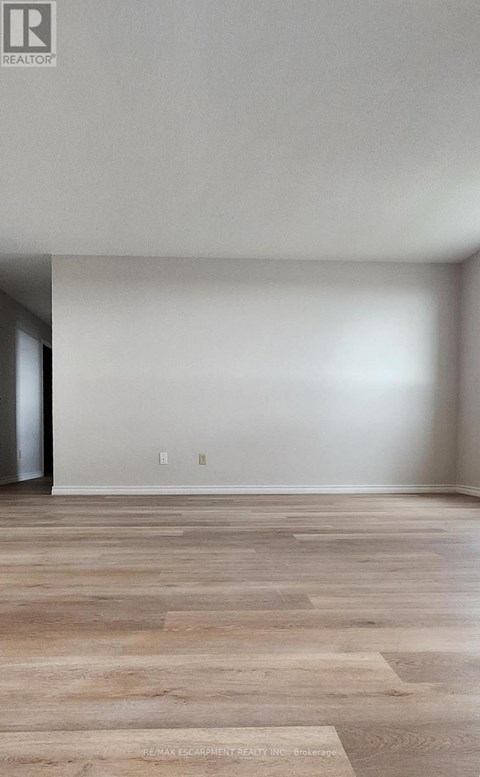 A room with a wooden floor and white walls.