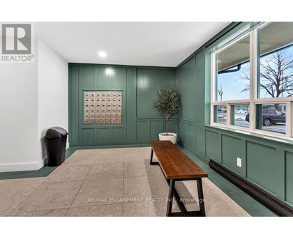 A room with a green wall and a wooden bench.