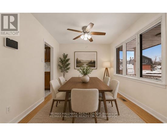 A dining room with a wooden table and chairs.