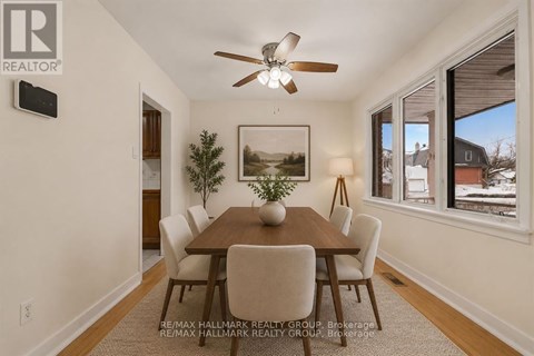 A dining room with a wooden table and chairs.