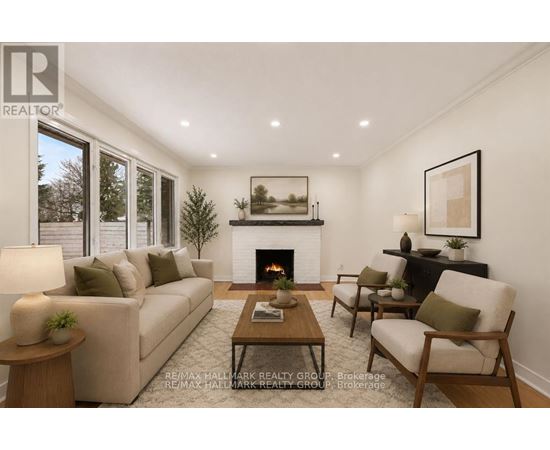 A living room with a fireplace and a painting on the wall.
