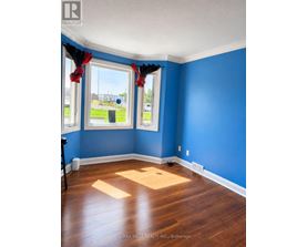A room with blue walls and wooden floors.