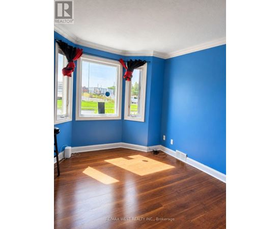 A room with blue walls and wooden floors.