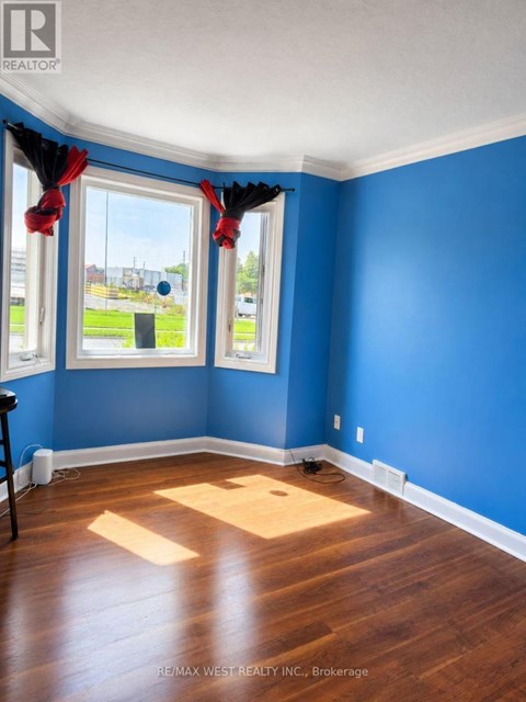 A room with blue walls and wooden floors.