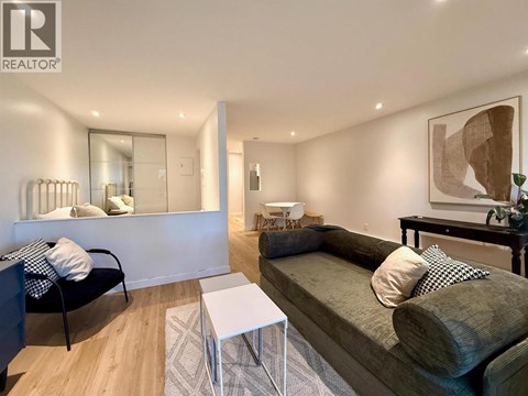 A living room with a couch, chair, and coffee table.