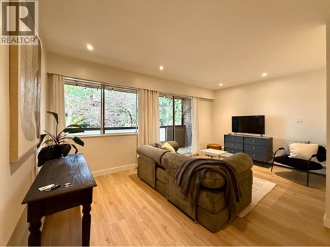 A bedroom with a large bed and a television.